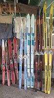 Six pairs of skis standing upright