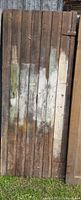 Front of barn wood door showing vertical planks and paint remnants