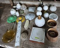 Top view of entire assortment of lamp parts, shades and homemade lamp base