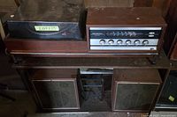 Full view of receiver, turntable on top of stand with speakers below