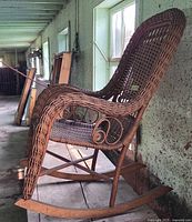 Profile view of wicker rocking chair showing high back and rockers