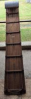 full length view of wooden toboggan sled showing rope rails