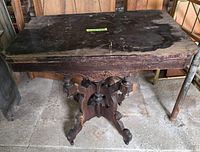 Full view of table front, showing carved pedestal and base