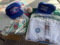 Overview of memorabilia items including caps, sealed apparel, baseball, cards, pennants, and pens
