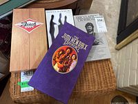 Four classic rock CD box sets displayed together; includes The Jimi Hendrix Experience (purple box), Thirty Years of The Beach Boys (wooden box), Genesis Archive 2 (white cover) and Eric Clapton Crossroads booklet.