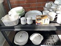 Overall view of the Corelle Iris dinnerware set with plates, bowls, covered baking dishes, cups, saucers, and salt & pepper shakers.