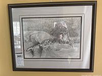 Framed pencil sketch artwork showing full image of reclining leopard signed by Donna Weatherall