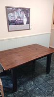 Full view of pine tabletop table with black legs