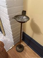 Full view of the brass ashtray stand and glass ashtray showing overall height and condition.