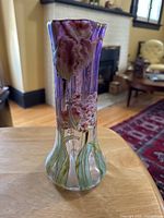 Front and side views of purple amethyst to clear glass vase with enameled flowers and leaves, showing detailed enamel work and crack on bottom.