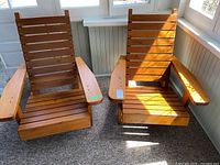 Pair of pine Muskoka chairs side by side, showing overall condition and style