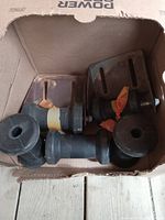 Five boat rollers placed inside a cardboard box, showing two rollers with metal brackets and three loose rubber rollers.