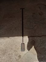 Photo of the metal ice chipper displaying the full length and chipping head.