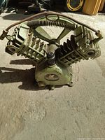 Front view of Swan air compressor motor showing the two V-shaped cylinders and connecting tubing.