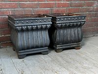 Front view of both planters side by side against a brick wall showing overall style and condition