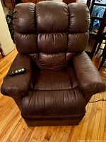 Front view of chair with remote on left armrest