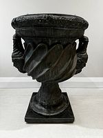 Full front view of very large classical urn showing twisted handle and sculpted details.