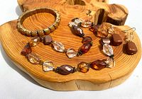 Full view of necklace, bracelet, earrings showing overall design and colors