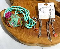 Bracelet and earrings together on wood display