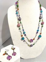 Necklace on display bust with earrings shown