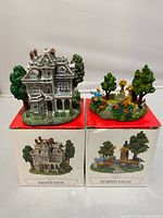 Haunted House and Pumpkin Patch figurines on top of their original boxes front view
