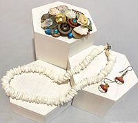 Group view showing brooch, necklace and earrings on display blocks