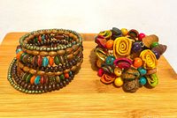 Both bracelets side by side on wood board