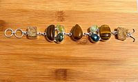 Full view of gemstone bracelet laid flat showing all stones and clasp