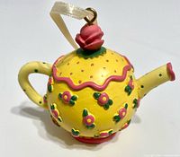 Full view of teapot ornament showing color, shape, ribbon hanger
