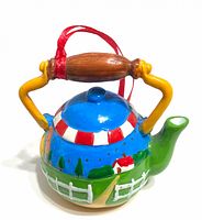 Front view of multicolor resin teapot ornament with ribbon