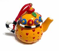 Front three-quarter view of teapot ornament showing design and ribbon