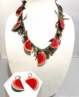 Necklace on stand with dangling watermelon charms and earrings displayed