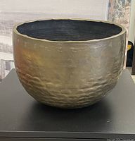 Front side view showing the hammered texture and engraved characters on the bowl's upper exterior.