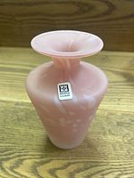 Side angle showing pink marbled glass vase with Mdina Glass label, highlighting shape and pattern