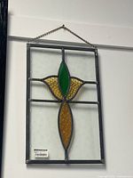 Front view of 16x11 stained glass panel hanging on wall, showing full design and chain.