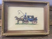 Frontal view of the framed cross-stitch horse and carriage art showing overall composition and frame condition.