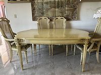 Full view of dining table and chairs set against wall