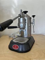 Front-left angle view showing lever assembly, brew head, drip tray and base.