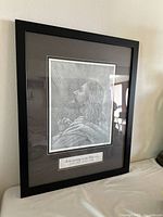 Framed artwork angled to show entirety and frame style.