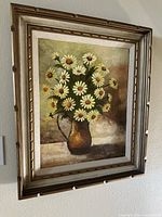 Front view of the full framed still life painting showing flowers and vase.