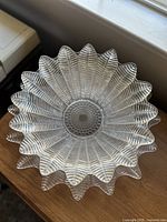 Top view of the crystal bowl showing the detailed feather and fern pattern with scalloped edges.