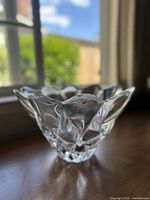 Side and angled view of the vintage Orrefors crystal daisy bowl dish showing the scalloped petal edges and clear faceted crystal pattern.
