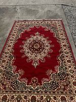 Full view of the vintage carpet showing overall size, color, and central medallion pattern.