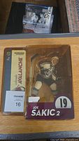 Front view of Joe Sakic Colorado Avalanche NHL Series 2 McFarlane action figure in packaging with cardboard backing and taped plastic.