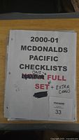 Photo of the printed cover sheet for the 2000-01 McDonald's Pacific checklist booklet, marked with notes on the set status.