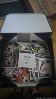 Box filled with loose NHL hockey cards, multiple teams and players visible.