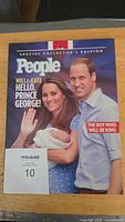 Front cover showing Prince William, Kate Middleton with baby Prince George, with main headline about Prince George's birth.