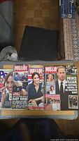 Four magazines stacked with covers visible featuring British Royals including Meghan Markle, Prince William, and Kate Middleton.