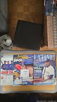 Three sports magazines displayed side by side: one with Toronto Blue Jays players, the second featuring Josh Donaldson on the cover, the third is a Latinus magazine showing a baseball player in white uniform.