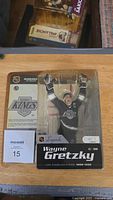 Front of package showing Wayne Gretzky figure in Los Angeles Kings uniform with arms raised and graphic label including name and years 1988-1996.